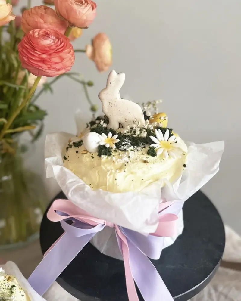 Paska Easter bread decorated with meringue bunny and spring flowers